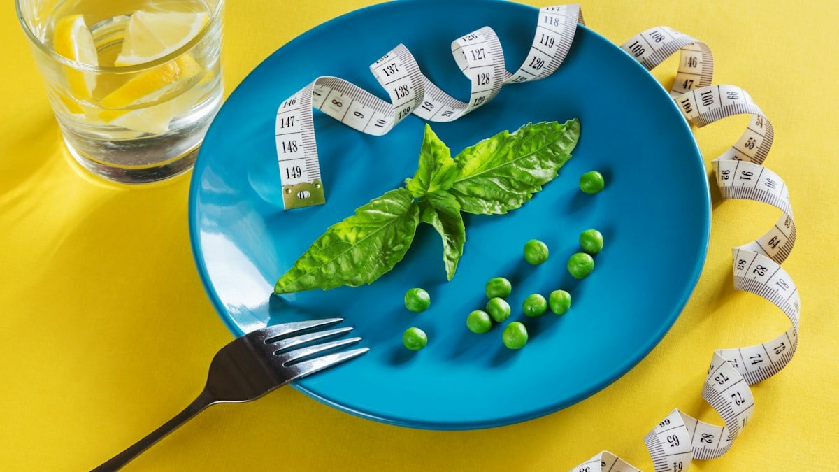 Diet blue plate with centimeter peas and basil